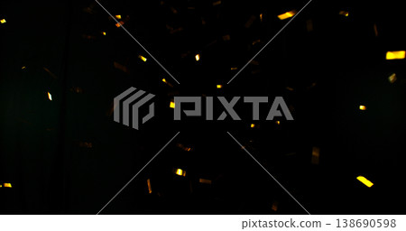 Flying golden confetti on black background. Shiny particles suspended in the air with dramatic lighting, creating a festive, luxury and celebratory atmosphere. Flying golden confetti on black background. Shiny particles suspended in the air with dramatic lighting, creating a festive, luxury and celebratory atmosphere. 138690598
