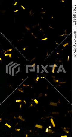 Flying golden confetti on black background. Shiny particles suspended in the air with dramatic lighting, creating a festive, luxury and celebratory atmosphere. Flying golden confetti on black background. Shiny particles suspended in the air with dramatic lighting, creating a festive, luxury and celebratory atmosphere. 138690615