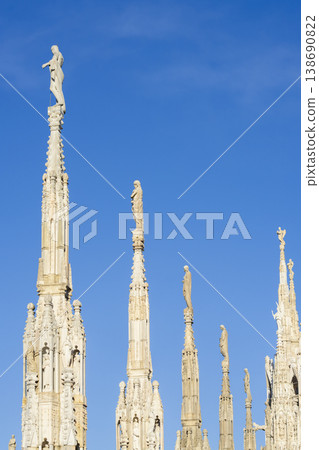 Details of marble spiers and statues of Milan Cathedral at sunny day 138690822