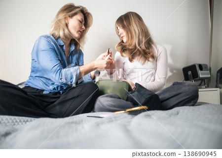 Women sharing beauty routine for a daily makeup preparation Women sharing beauty routine for a daily makeup preparation 138690945