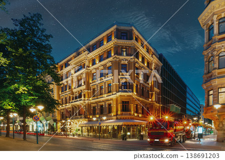 Helsinki, Finland. Car Performs Drainage Work On Corner Of Pohjoisesplanadi And Kluuvikatu Streets. Night View Of Pohjoisesplanadi Str In Kluuvi District In Evening, Night Illumination Helsinki, Finland. Car Performs Drainage Work On Corner Of Pohjoisesplanadi And Kluuvikatu Streets. Night View Of Pohjoisesplanadi Str In Kluuvi District In Evening, Night Illumination 138691203
