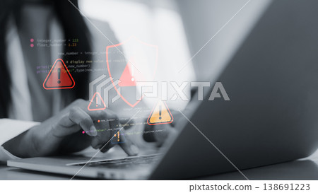 Cyber security alert with red warning icons on laptop screen.Hacker attack and data breach concept in modern office.System error and software vulnerability notification interface.Technology background Cyber security alert with red warning icons on laptop screen.Hacker attack and data breach concept in modern office.System error and software vulnerability notification interface.Technology background 138691223