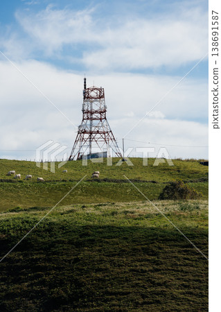 Communication Tower on a Green Hillside Communication Tower on a Green Hillside 138691587