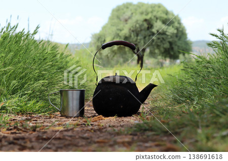 black camping teapot and metal cup black camping teapot and metal cup 138691618