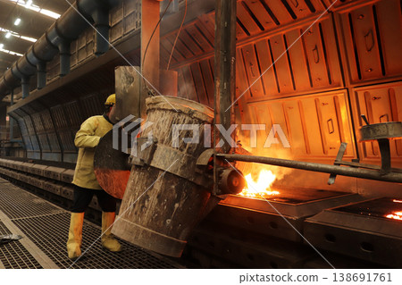 Metal industry work pouring molten metal Metal industry work pouring molten metal 138691761