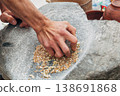 Ancient stone grinding tool with upper and lower stones, used for milling grains 138691868