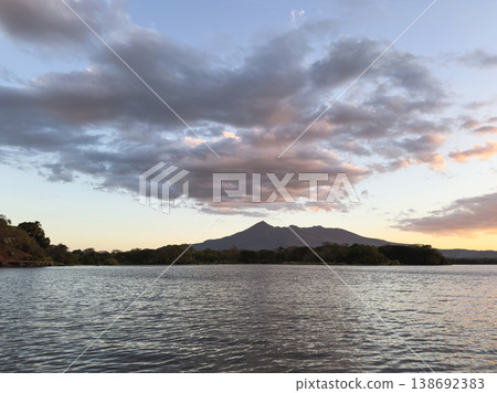 Sunset over the lake with mountain view in the background Sunset over the lake with mountain view in the background 138692383