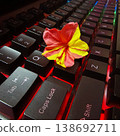 Small pink and yellow flower resting on black mechanical gaming keyboard with red backlight. 138692711