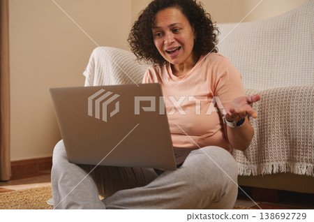 Surprised woman reacting to laptop screen at home Surprised woman reacting to laptop screen at home 138692729