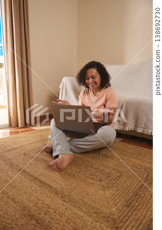 Happy woman using laptop at home, positive online communication Happy woman using laptop at home, positive online communication 138692730