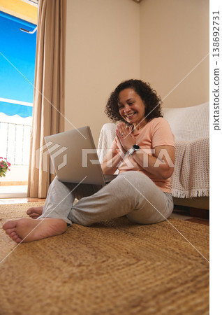Grateful woman using laptop at home, relief and success Grateful woman using laptop at home, relief and success 138692731
