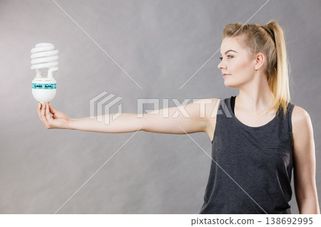 Woman holding eco modern light bulb Woman holding eco modern light bulb 138692995
