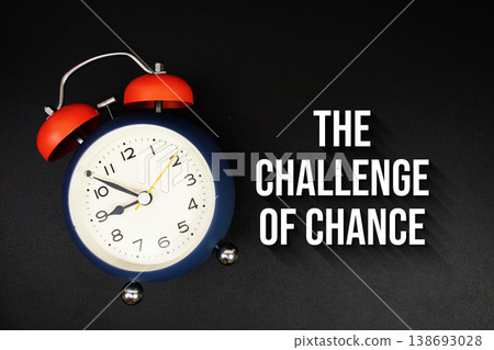 The Challenge Of Chance text with alarm clock on black background The Challenge Of Chance text with alarm clock on black background 138693028