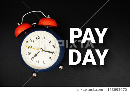 Pay Day text with alarm clock on black background 138693070