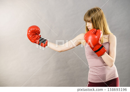 Woman wearing boxing gloves Woman wearing boxing gloves 138693196