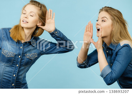 Two women telling tales, rumors gossip 138693207