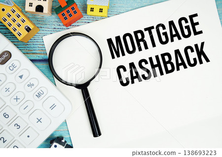 Notepad with "Mortgage Cashback" with Calculator, magnifying glass and house model on wooden background Notepad with "Mortgage Cashback" with Calculator, magnifying glass and house model on wooden background 138693223