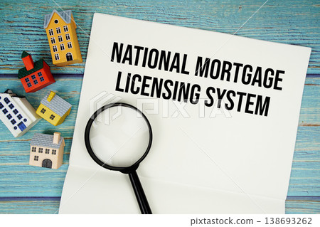 Notepad with "NMLS National Mortgage Licensing System" with magnifying glass and house model on wooden background Notepad with "NMLS National Mortgage Licensing System" with magnifying glass and house model on wooden background 138693262