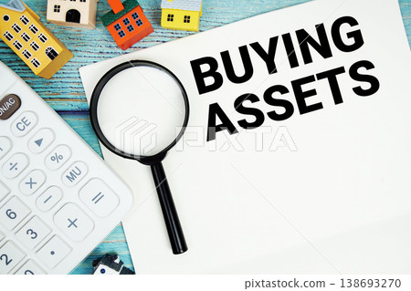 Notepad with "Buy Or Rent?" with Calculator, magnifying glass and house model on wooden background 138693270