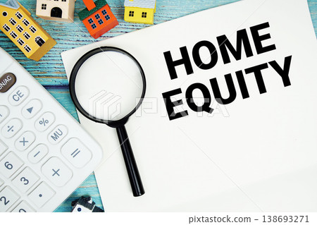 Notepad with "Home Equity" with Calculator, magnifying glass and house model on wooden background 138693271