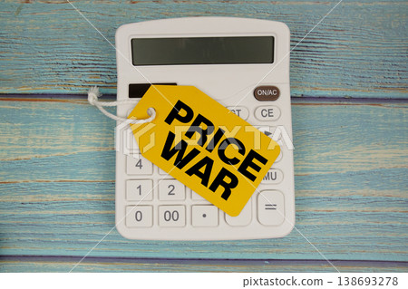 Price tag with "PRICE WAR" on calculator on a rustic blue wooden surface Price tag with "PRICE WAR" on calculator on a rustic blue wooden surface 138693278