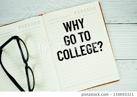 Notepad with message "Why Go To College?" and eyeglass on wooden background 138693321