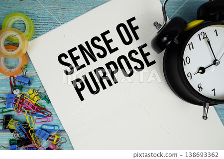 Sense Of Purpose text with alarm clock and colorful office supplies on a blue wooden surface 138693362