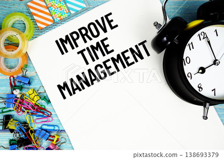 Improve Time Management text on a paper surrounded by office supplies and a clock on a blue wooden surface Improve Time Management text on a paper surrounded by office supplies and a clock on a blue wooden surface 138693379