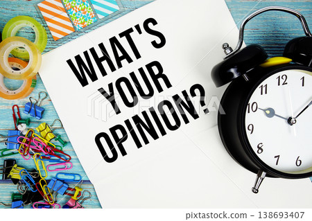 What's Your Opinion? text with alarm clock and colorful office supplies on a blue wooden surface What's Your Opinion? text with alarm clock and colorful office supplies on a blue wooden surface 138693407