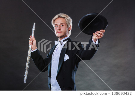 Elegantly dressed musician holding flute Elegantly dressed musician holding flute 138693422