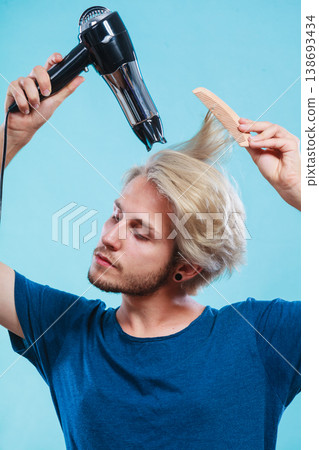 Trendy man with hair dryer Trendy man with hair dryer 138693434