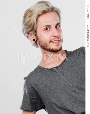 Happy smiling blonde man in grey t shirt Happy smiling blonde man in grey t shirt 138693440