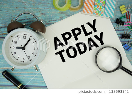 Apply Today text written on notepad with alarm clock and magnifying glass flat lay on wooden background Apply Today text written on notepad with alarm clock and magnifying glass flat lay on wooden background 138693541