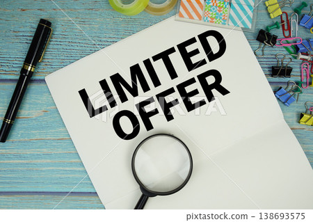 Limited Offer text written on notepad with magnifying glass flat lay on wooden background 138693575