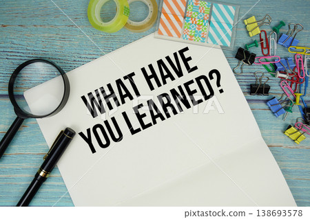 How To Handle Changes? text on a paper surrounded by office supplies and magnifying glass on a blue wooden surface 138693578