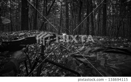 Wehrmacht machine gunner firing MG34 in forest trench during WWII battle 138694115