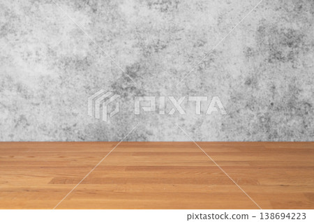 An empty wooden tabletop against a gray concrete wall. A minimalist style on a neutral background. An empty wooden tabletop against a gray concrete wall. A minimalist style on a neutral background. 138694223