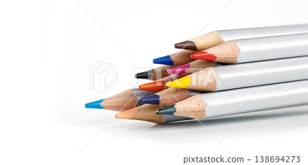 Silver-barreled colored pencils stacked horizontally with clean white copy space to the left Silver-barreled colored pencils stacked horizontally with clean white copy space to the left 138694273