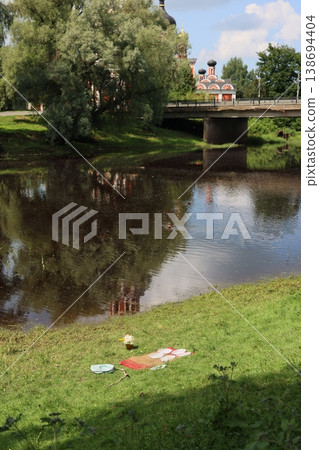 Idyllic summer scene featuring outdoor dining and serene waterways 138694404