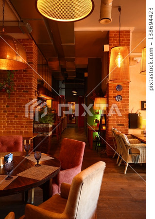 Peaceful haven furnished with comfortable chairs and lighting Peaceful haven furnished with comfortable chairs and lighting 138694423