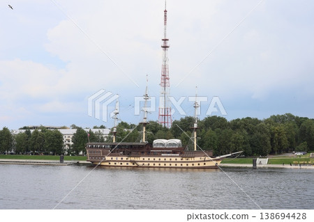 Vintage tall ship with detailed rigging and surrounding modern structures 138694428