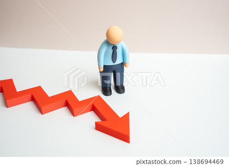 A businessman is upset by a drop in income during an economic crisis. Financial instability affects operations. Declining revenue forces difficult decisions and highlights business vulnerability. 138694469