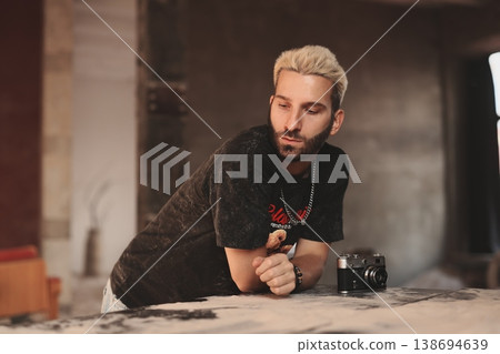Focused white camera technician testing vintage camera Focused white camera technician testing vintage camera 138694639