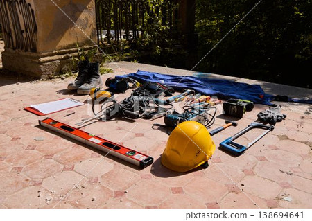Brightly lit workspace showcasing protective gear and hand tools Brightly lit workspace showcasing protective gear and hand tools 138694641