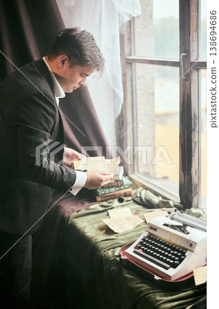 Committed researcher categorizes vintage documents carefully Committed researcher categorizes vintage documents carefully 138694686