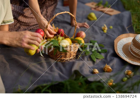 Preparing outdoor picnic with fresh fruits and natural sunlight 138694724