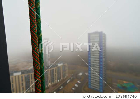 Serene morning scene featuring misty buildings and silent parking lot Serene morning scene featuring misty buildings and silent parking lot 138694740