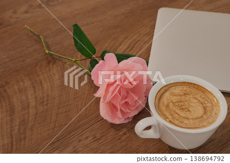 feminine freelance workspace: stylish desk with flowers, coffee, and technology for digital work feminine freelance workspace: stylish desk with flowers, coffee, and technology for digital work 138694792
