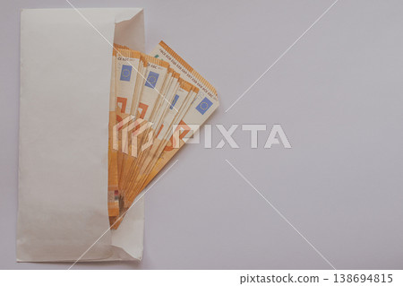 Fan of 50 Euro banknotes inside an open white envelope on a light background. Minimalist financial composition with a large copy space for business or legal text Fan of 50 Euro banknotes inside an open white envelope on a light background. Minimalist financial composition with a large copy space for business or legal text 138694815