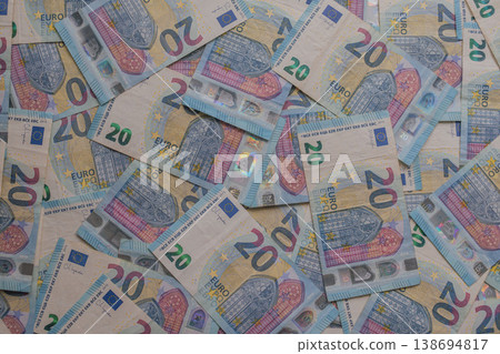 Dense texture of 20 Euro banknotes in a dynamic arrangement. Detailed macro shot of blue European currency featuring holograms and watermarks. Financial abundance concept 138694817